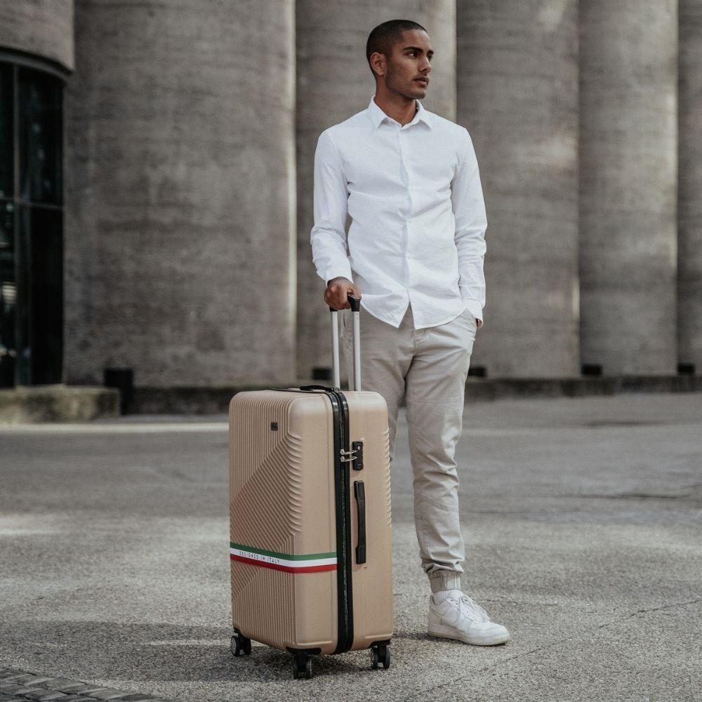 Man standing with Roma eco-friendly hardshell luggage in urban setting – lifestyle product image 01