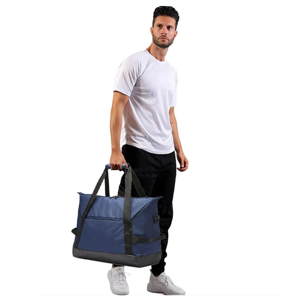 Lifestyle image of a man holding the TDB01 small duffel bag by his side, showcasing its compact scale, structured build, and versatile styling—ideal for urban travel or gym transitions