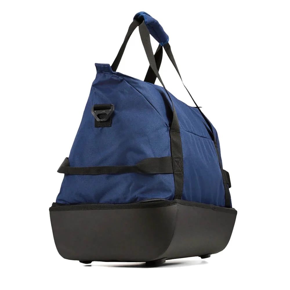 Studio image of the TDB01 small duffel bag shown from the side, highlighting its depth, low-profile silhouette, and compact EVA base—capturing its travel-friendly build in a clean, minimalist frame