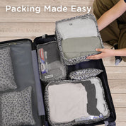 Lifestyle image of the Travel Storage 6-piece set arranged on a bed with clothing and travel gear, highlighting its versatility and organized design for efficient packing on the go