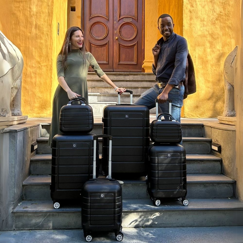 Man and woman with Milan eco-friendly luggage set on outdoor steps – lifestyle product image 03