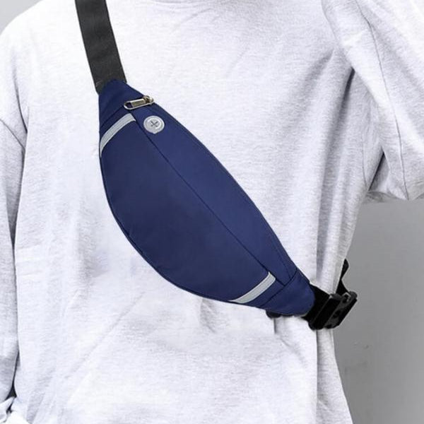 Lifestyle image of the Moon Bag worn across the body in an everyday setting, highlighting its curved silhouette, sleek profile, and hands-free design ideal for casual travel or urban movement